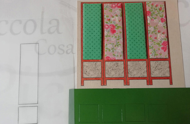 The four rectangles of the screen are already upholstered. The other four square parts of the screen are traced on a green card.